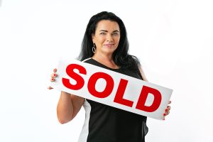 Selling a home Port St Lucie – Realtor holding SOLD sign