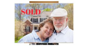 Happy Florida homeowners standing in front of their sold home on the Treasure Coast