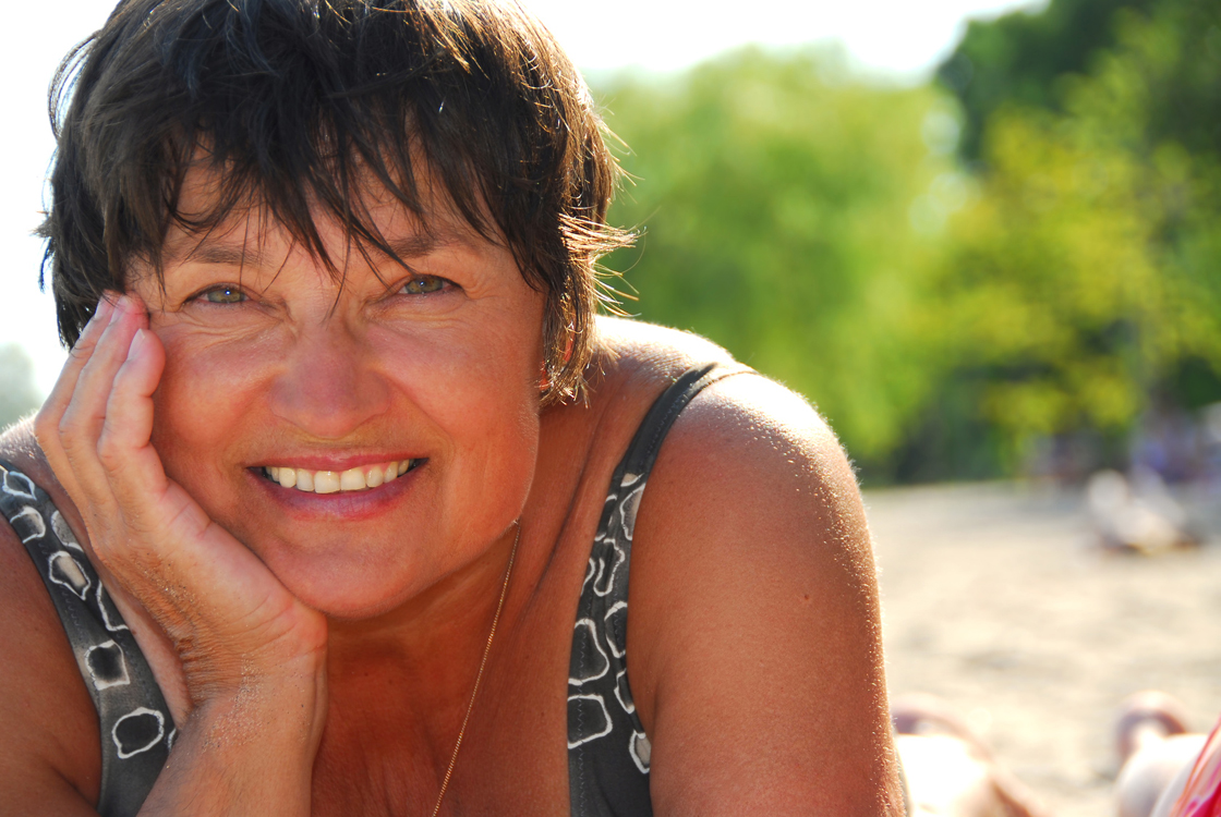 Smiling woman relaxing on a sunny Florida beach