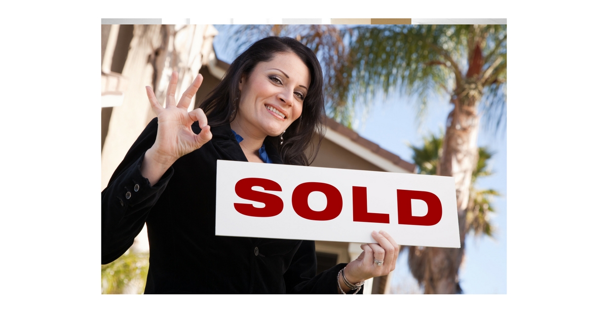 Realtor holding a SOLD sign, representing strong opportunities in the Florida Real Estate Market 2026