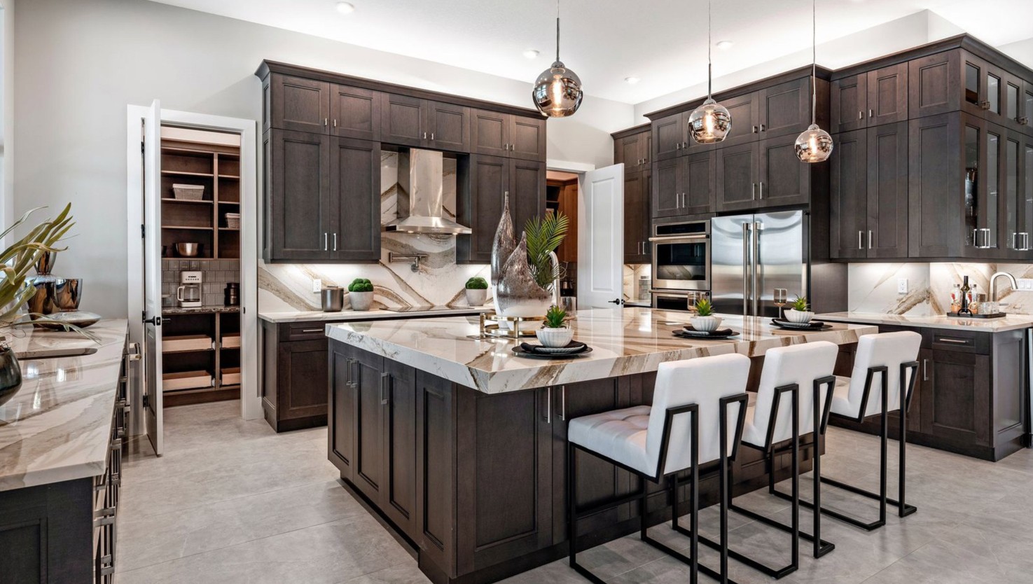 Waverly model Astor Creek kitchen featuring a double door walk-in pantry